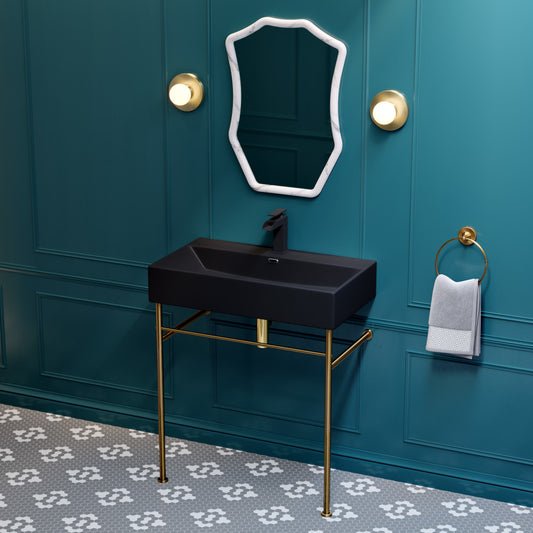 Matte black ceramic console sink with slim brushed gold legs and rectangular basin.