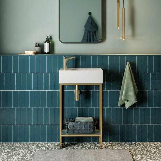 19.5-inch freestanding bathroom vanity with gold metal frame, single white basin, and open lower shelf.