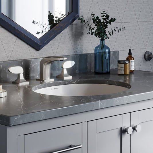 16.5-inch oval under-mount bathroom sink in white porcelain with smooth edges and modern countertop installation.