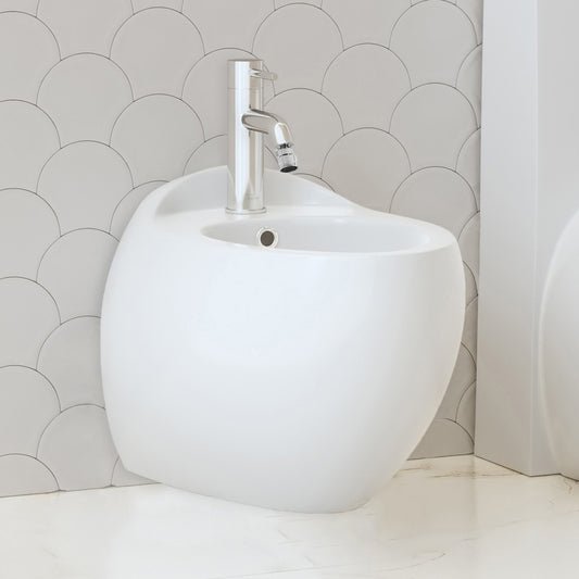 Wall-hung classic bidet in white ceramic with single-handle chrome faucet and overflow hole.