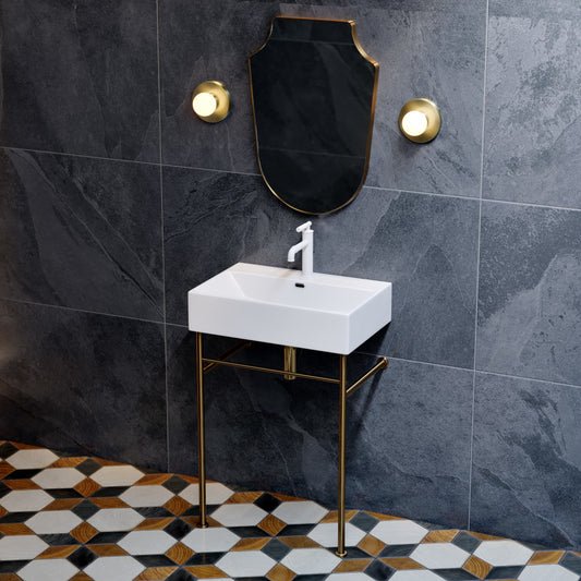White ceramic console sink with brushed gold legs and single-handle faucet, rectangular basin.