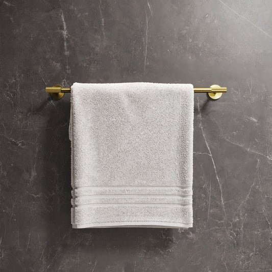 24-inch towel bar in brushed gold with mounted white towel on dark marble wall.